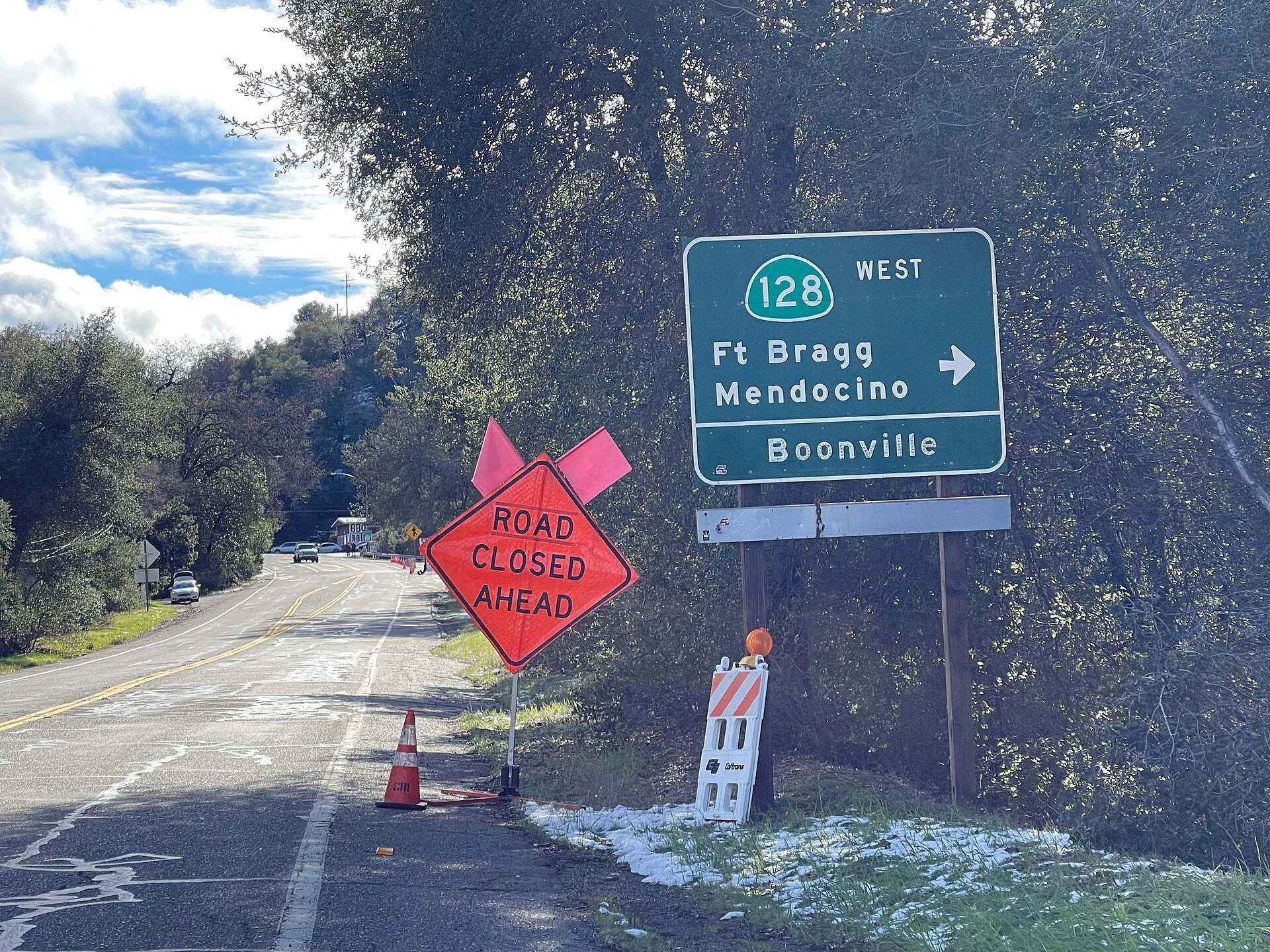 SR 128 sign and road closure in Cloverdale, California, due to snow after the Feb 22-24 2023 storm. Four slow travel mistakes: road closures, posted notices, and weather