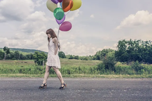balloons, girl, walking, street, celebration, bunch, colors, woman, high heels, dress, legs, redhead, hair, country, happy birthday, road, nature, grass, fields, trees