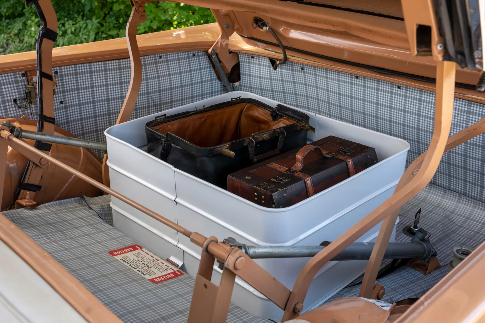 Open trunk of a vintage car with retro suitcases inside, captured outdoors in Nelson, Wisconsin. The short packing list that prevents the usual slow travel mistakes